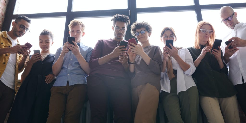 group of people on phones in public Qujam geofence advertising