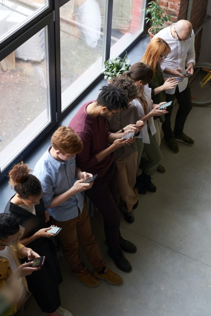 group of people on phones in public Qujam geofencing